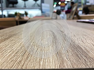 Empty wooden table in front of abstract blurred background of office