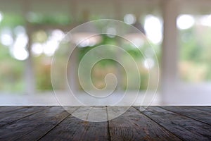 Empty wooden table in front of abstract blurred Cafe, restaurant at night. For montage product display or design key visual layout