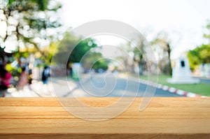 empty wooden table in front of blur montage abstract background