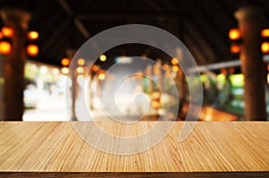 empty wooden table in front of blur montage abstract background