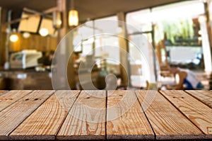 Empty wooden table in front of blur montage abstract background