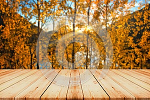 Empty Wooden Table in Front of Blurred Colorful Autumn Landscape Background