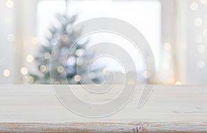 Empty wooden table in front of blurred winter festive background