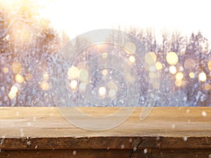 Empty wooden table in front of dreamy and magical winter landscape background. For product display montage.