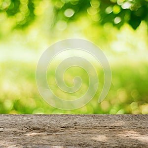 Empty Wooden Table in the Garden with Bright Green Background