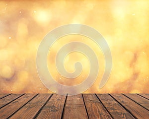 Empty wooden table on a gold blurred background.