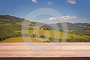 Empty wooden table for montage and display your products on the background of Tuscany landscape