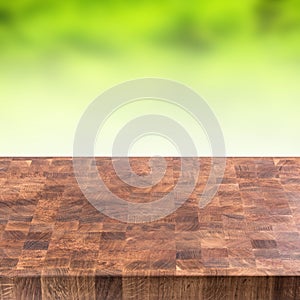 Empty wooden table and montage green summer background