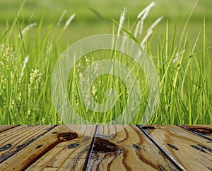 Empty wooden table on nature grass flower background. Mock up for your product display or montage