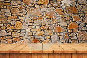 Empty wooden table and old stone wall background