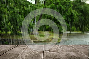 Empty wooden table on rainy day
