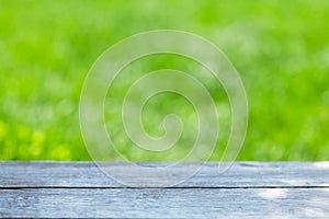 Empty wooden table over bokeh natural background