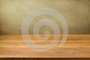 Empty wooden table over grunge background.