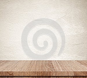 Empty wooden table over grunge cement wall background, product d