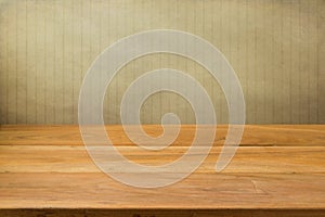 Empty wooden table over grunge striped background.