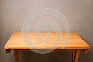 Empty wooden table over grunge wall background for product montage