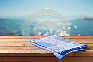 Empty wooden table over sea beach bokeh background. Summer picnic on beach background