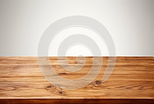 Empty wooden table over white wall background, for product display montage