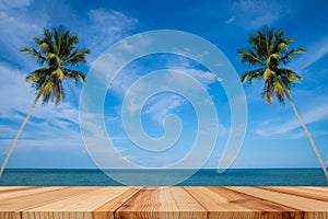 Empty wooden table and palm leaves with party on beach background in summer time, Tropical palm on a paradise island