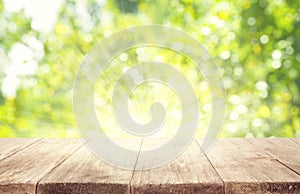 Empty Wooden Table Planks over Green Blurred Trees Background