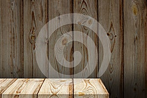 Empty wooden table or shelf against the background of the same wooden wall.