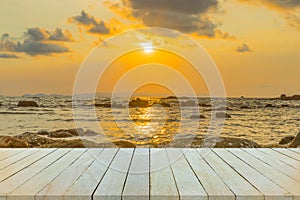 Empty wooden table or shelf wall with sunset or sunrise on sand.
