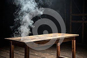Empty wooden table with smoke float up on dark background photo