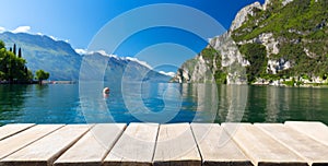Empty wooden table and summer view of lake Garda in Italy, Europe photo