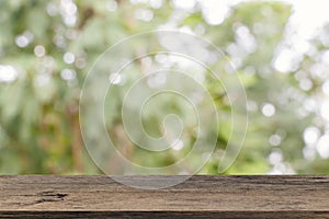 Empty wooden table template top on nature green blurred background for montage of your product on table.