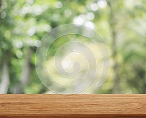 Empty wooden table template top on nature green blurred background for montage of your product on table
