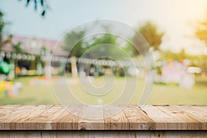 Empty wooden table top and Abstract blurred light bokeh and blur background of garden trees in sunlight. product display template