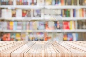 Empty wooden table top with Blur bookshelves in bookstore background.