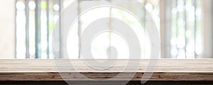 Empty wooden table top with blur office interior background, Panoramic banner. Abstract background