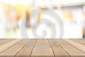 Empty wooden table top on blurred background at shopping mall