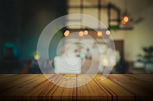 Empty wooden table top with blurred coffee shop or restaurant in