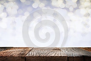 Empty wooden table top with defocused bokeh lights background