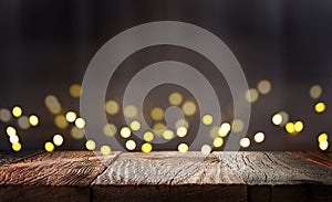 Empty wooden table top with defocused dark concrete wall background