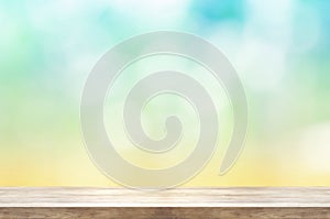Empty wooden table top front of blurred summer abstract background.