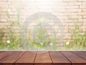Empty wooden table top on green blurred background
