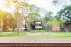 Empty wooden table top and green bokeh display montage for product with space.