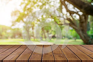 Empty wooden table top and green bokeh display montage for product with space.