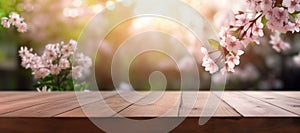 An empty wooden table top overlooking a blooming spring garden