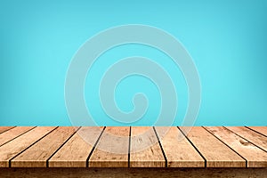 Empty wooden table top on pastel blue colour background, used for display or montage your products