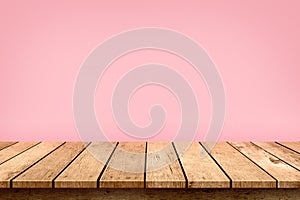 Empty wooden table top on pastel pink colour background, used for display or montage your products