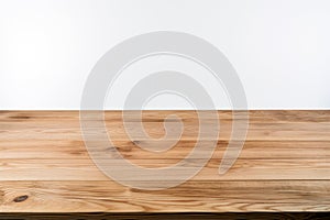Empty wooden table top on white wall background. For product display.