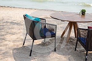 Wooden table with two chairs at beach restaurant