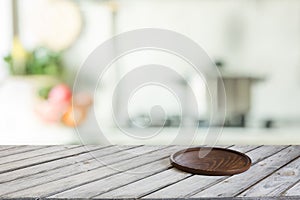 Empty wooden tabletop with cutting board and defocused modern kitchen for display or montage your products.