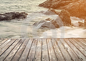 Empty wooden terrace over the sea and stone beach