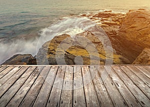 Empty wooden terrace over the sea and stone beach