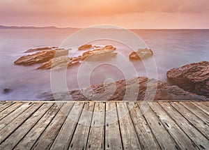 Empty wooden terrace over the sea and stone beach